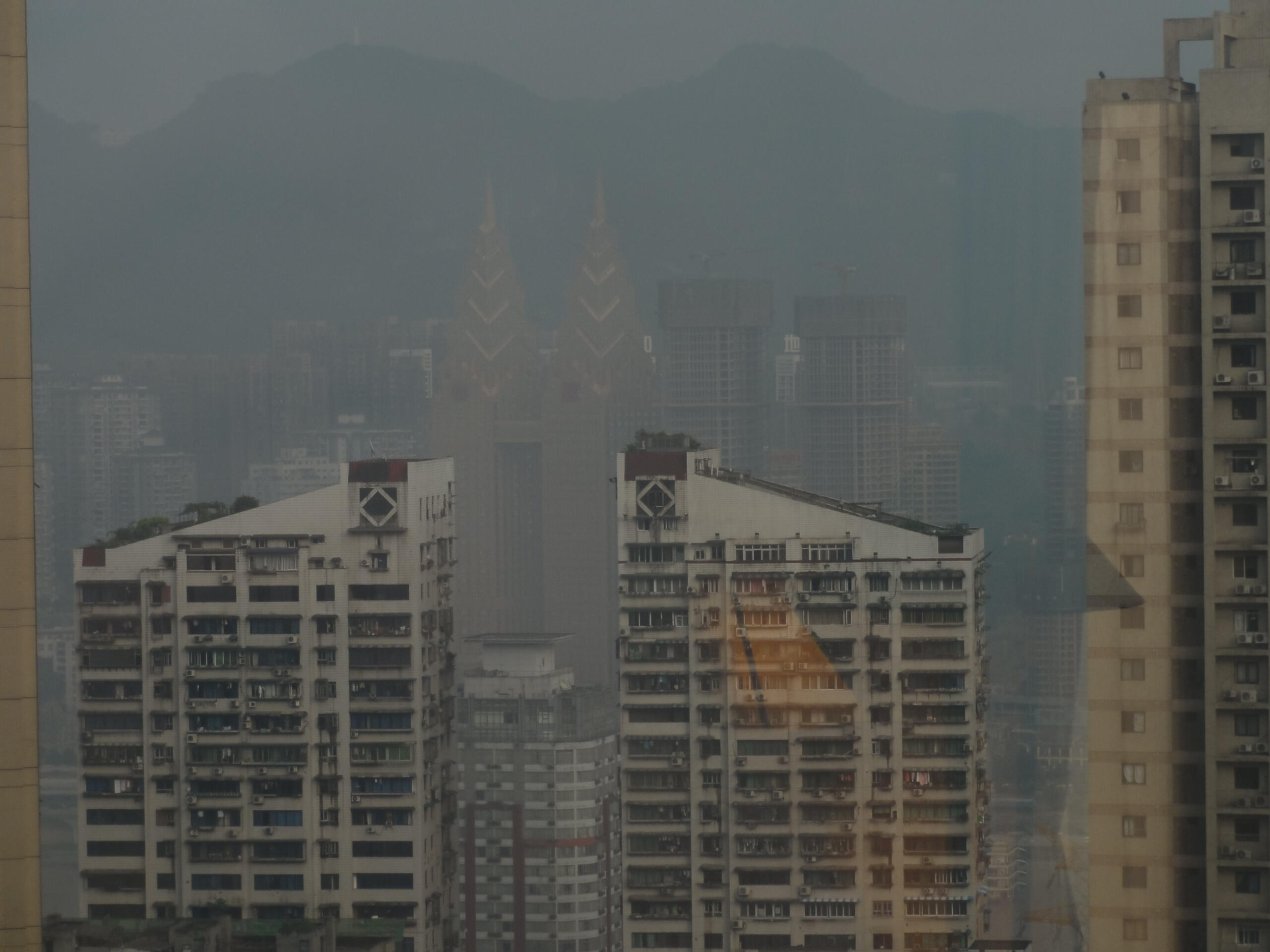 Leave me with the concrete; let the rain-soaked high-rise buildings grow taller until all I can see is the fog in their irises and the distant blue eyes of an apartment awake in the dark. When I look up, there is sky, and then there is concrete.